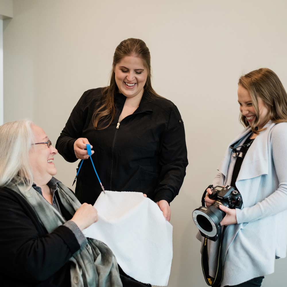 Photo of a dental patient and two team members