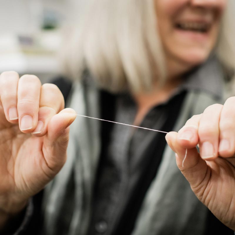 Close-up photo of hands holding dental floss