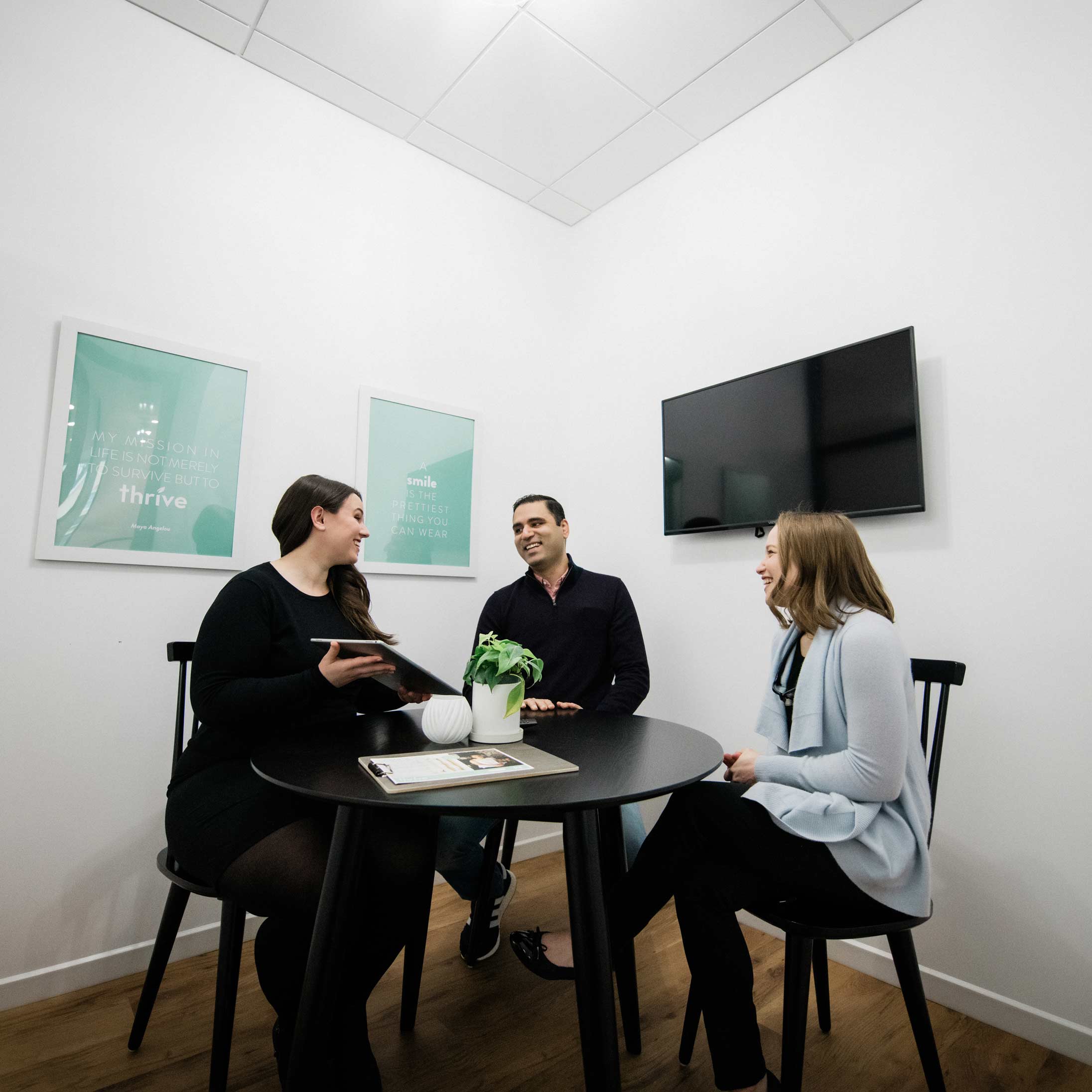 Photo of Dr. Jenny Citrin talking with a team member an a patient