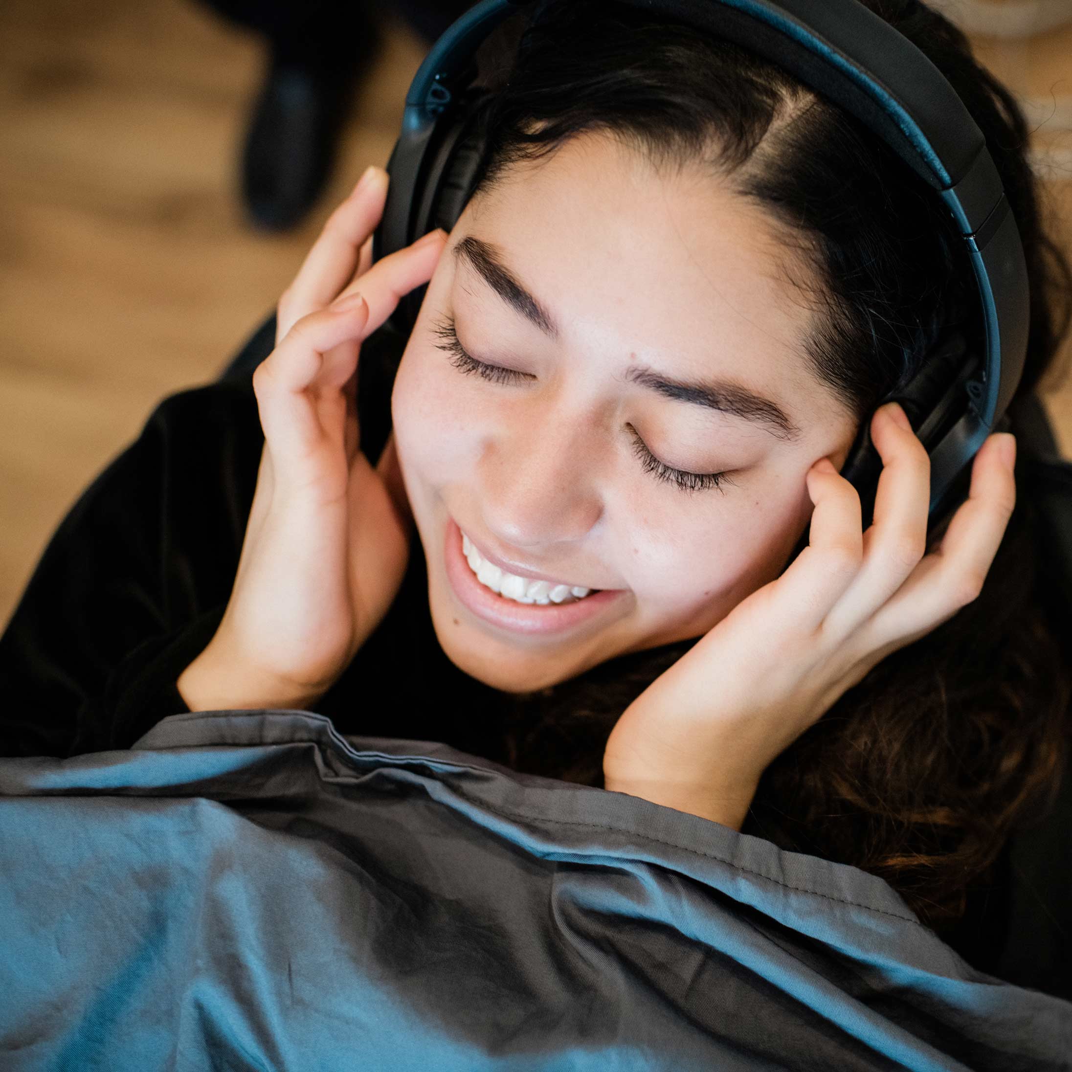 Photo of a relaxed dental patient wearing headphones