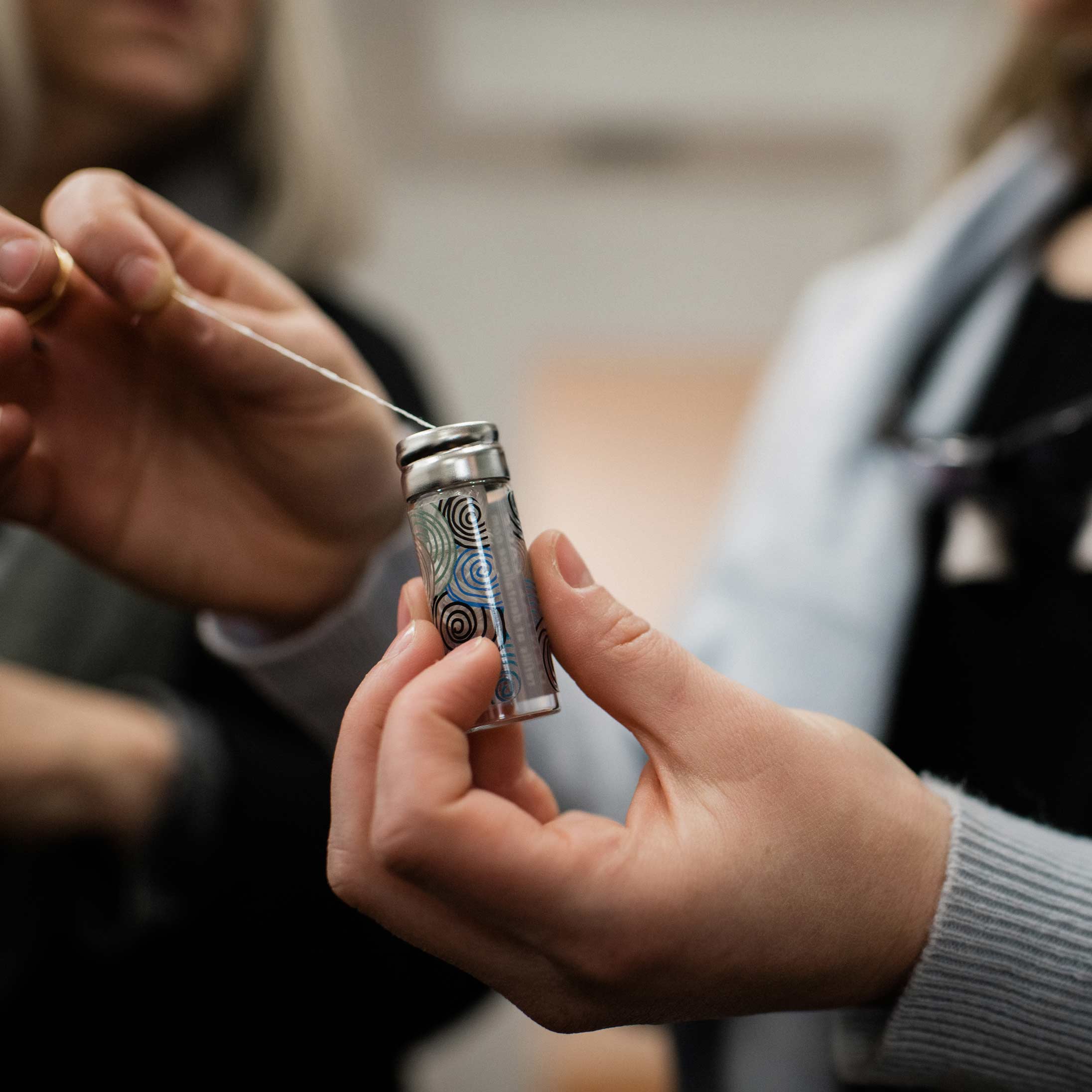 Close-up photo of a Thrive Dental team member holding dental floss